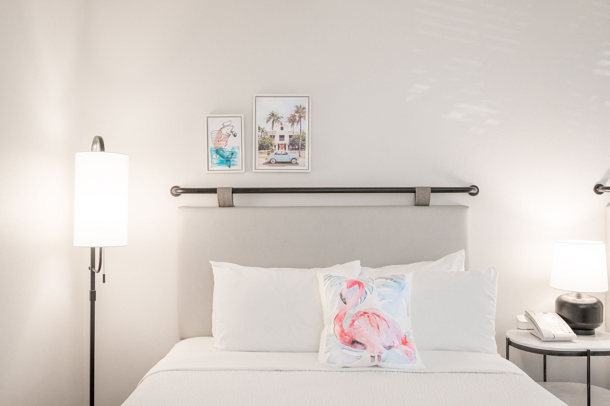 Flamingo pillow on a queen bed