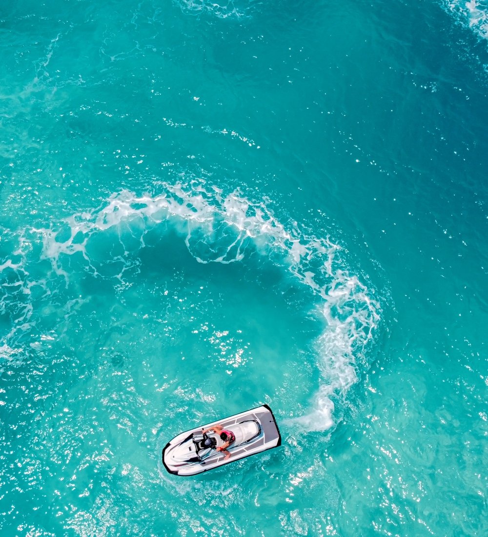 Three jet skis do circles in the ocean in Key West