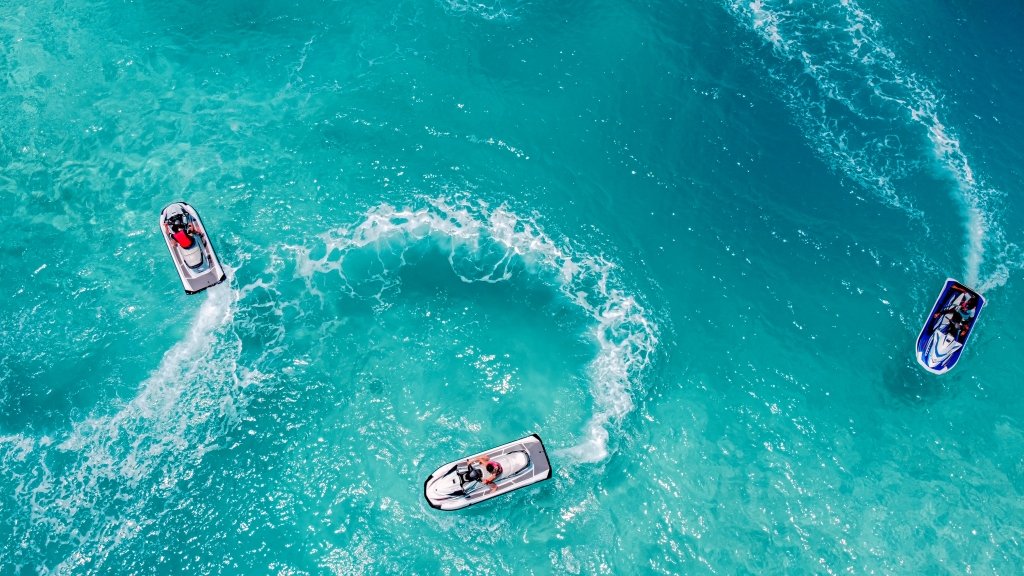 Three jet skis do circles in the ocean in Key West