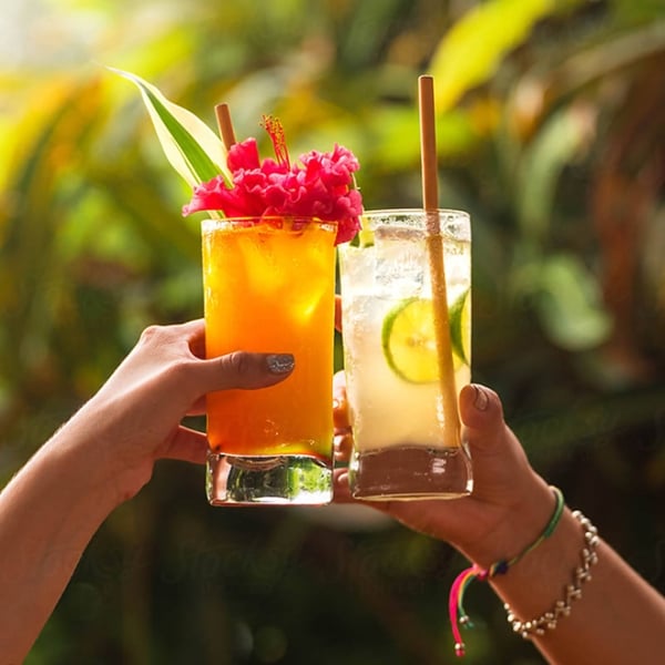 A 'cheers' with two tropical cocktails