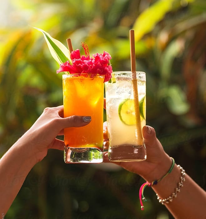 A 'cheers' with two tropical cocktails