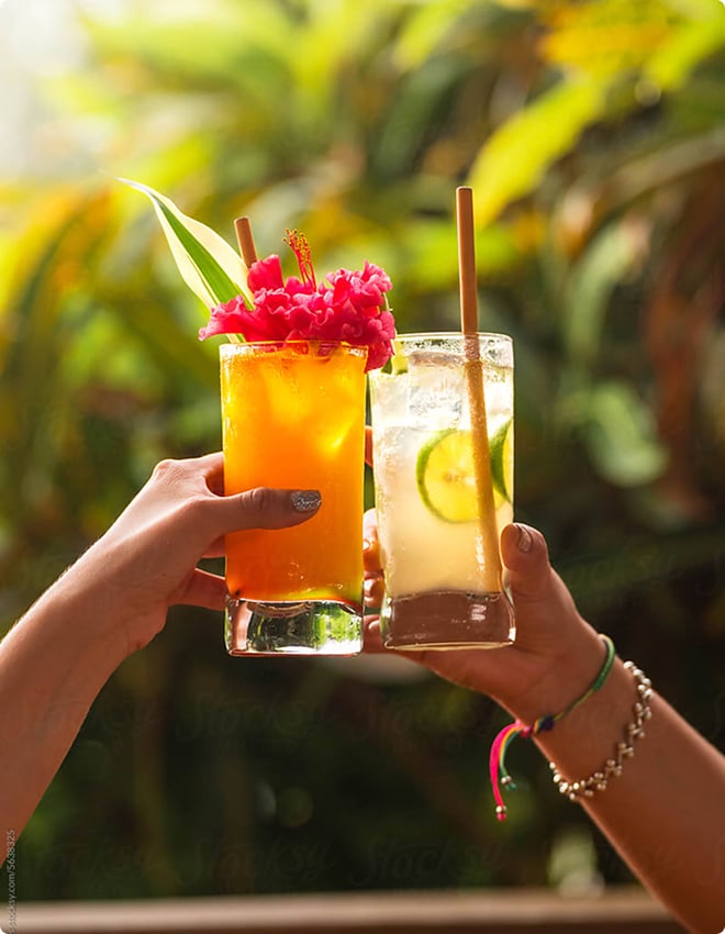 A 'cheers' with two tropical cocktails