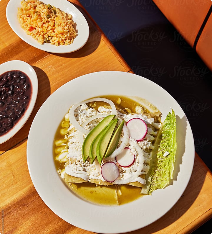 An elegant dish topped with feta, radishes and avocado