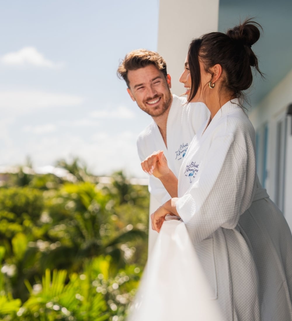 Couple in white robes on their rooms patio