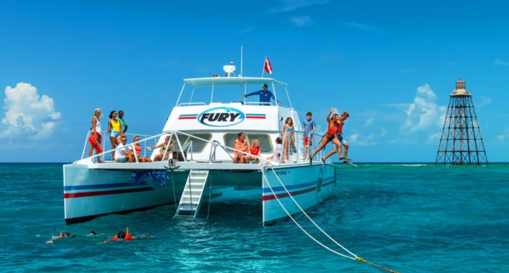Group enjoying a Key West catamaran excursion with snorkeling and ocean views near Blue Flamingo Resort.
