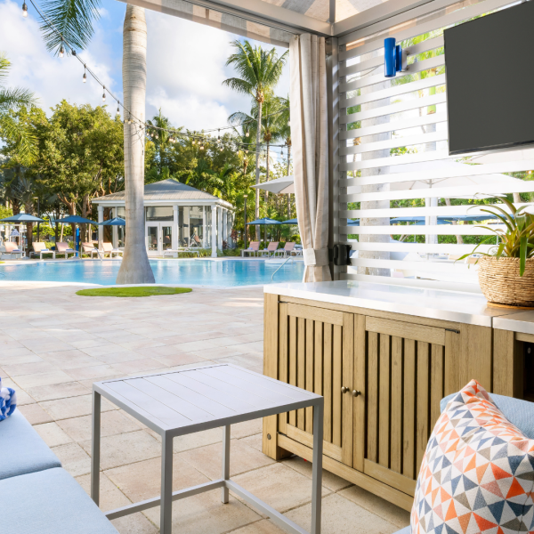 Luxury pool cabana with outdoor lounge seating, television, and resort pool views at Blue Flamingo Resort Key West.