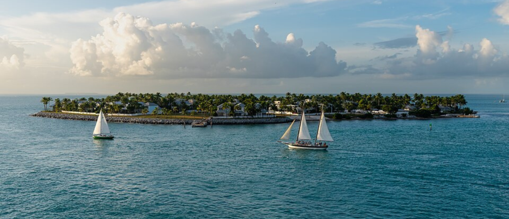 Sunset Key and surrounding water viewed from Key West beneath a colorful evening sky