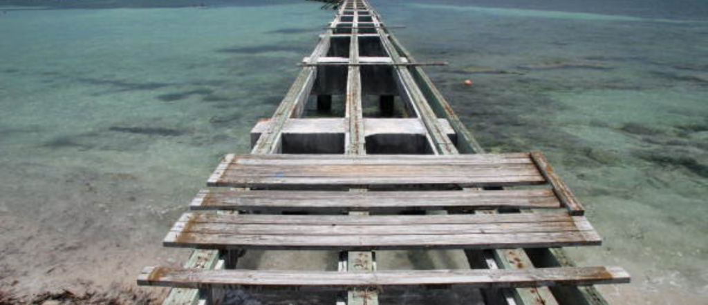 The wooden pier extending over the water at Higgs Beach in Key West