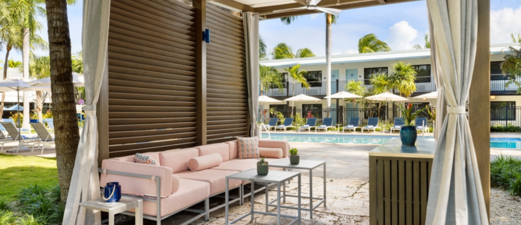 Private shaded poolside cabana with lounge seating at Blue Flamingo Resort Key West