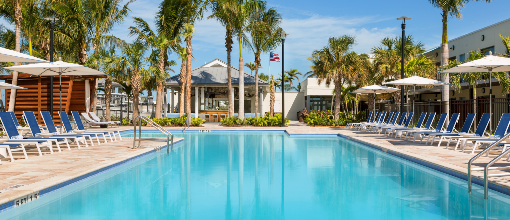 Lounge chairs, palm trees and a sparkling pool at Blue Flamingo Resort Key West