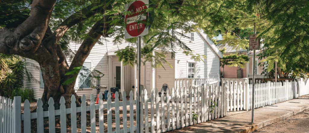 White picket fence, tropical greenery and a charming home on a quiet Key West street