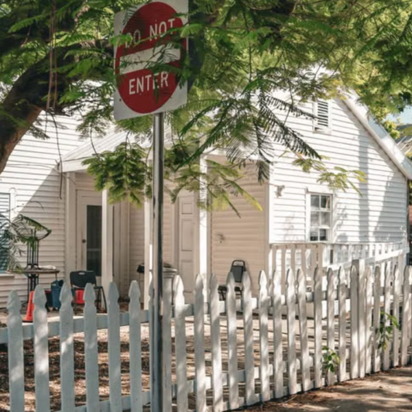 White picket fence, tropical greenery and a charming home on a quiet Key West street