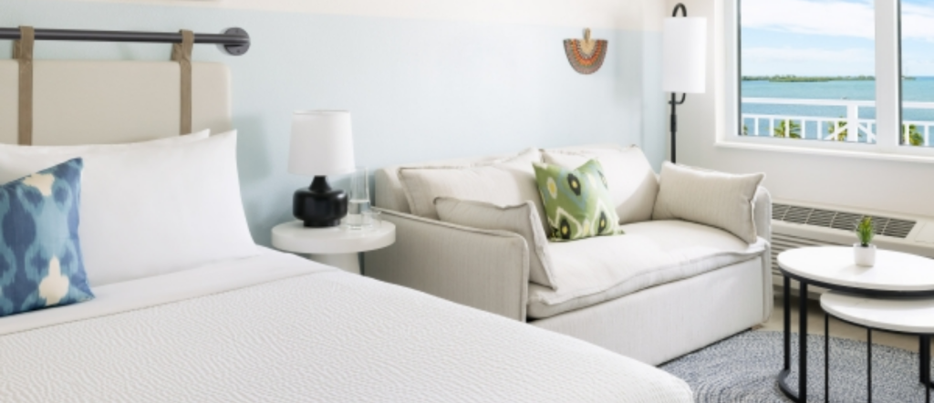 Bright ocean-view king guest room with modern tropical décor at Blue Flamingo Resort Key West