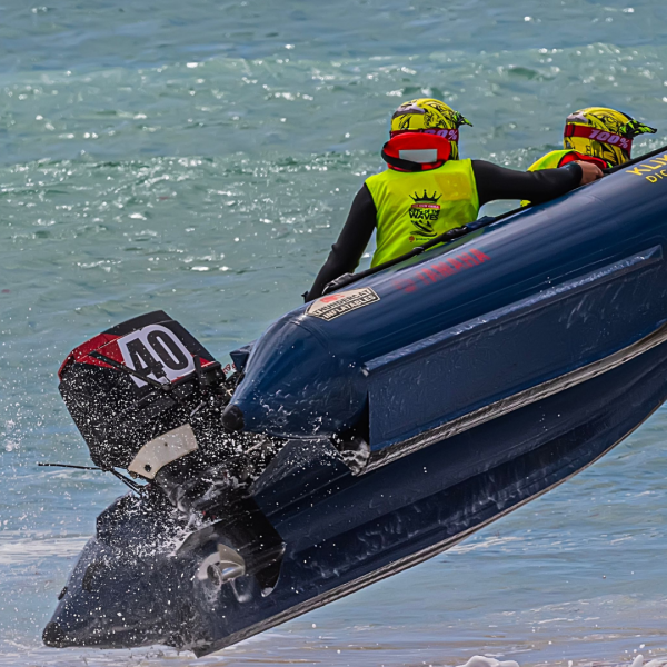 Offshore racing powerboat catching air above ocean waves