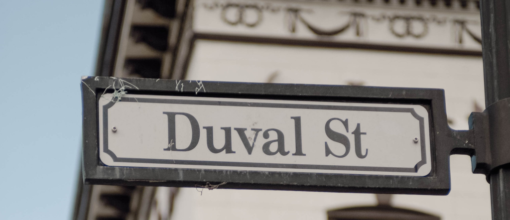 Duval Street sign beside a historic building and traffic light in Key West, Florida